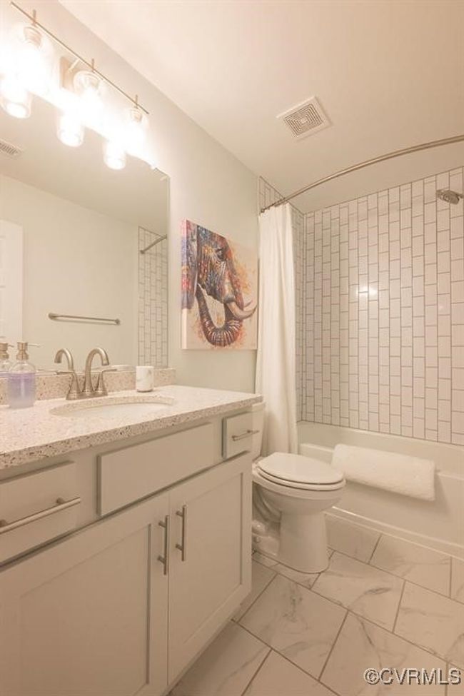 Bathroom with vanity, marble finish floors, and shower / tub combo | Image 41