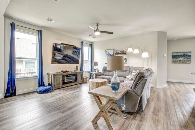 Living room featuring ceiling fan and wood finished floors | Image 5