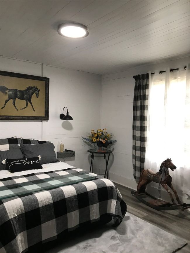 Bedroom featuring wood finished floors and wooden ceiling | Image 8