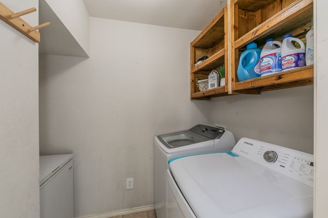 Laundry area with independent washer and dryer and baseboards | Image 32