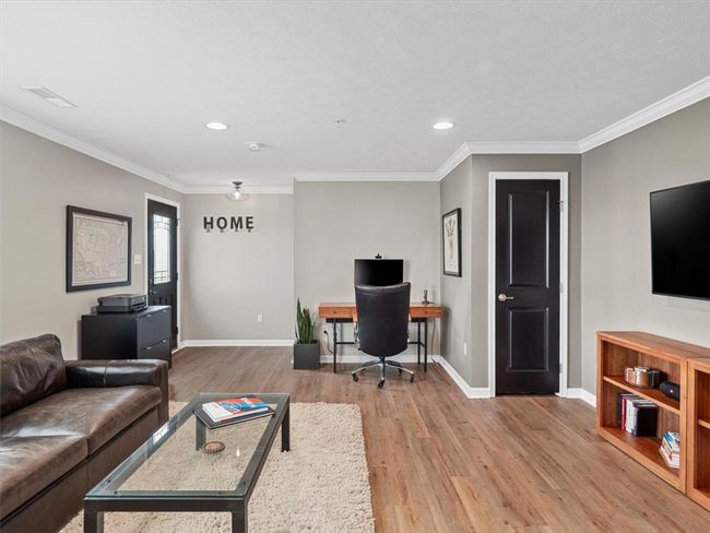Thoughtfully laid out, the room offers plenty of space for a full seating arrangement, media console, and accent pieces—ideal for everyday living or entertaining. The neutral palette provides a perfect backdrop for any décor style, while clean lines and contemporary finishes elevate the overall aesthetic. | Image 5