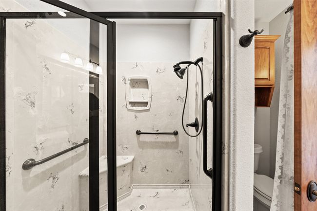 Bathroom featuring toilet and a shower | Image 22