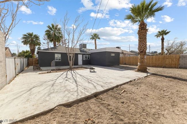 Rear view of house with a patio and a fenced backyard | Image 26