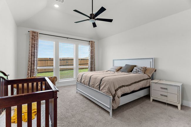 Bedroom with lofted ceiling, carpet flooring, a ceiling fan, and baseboards | Image 25
