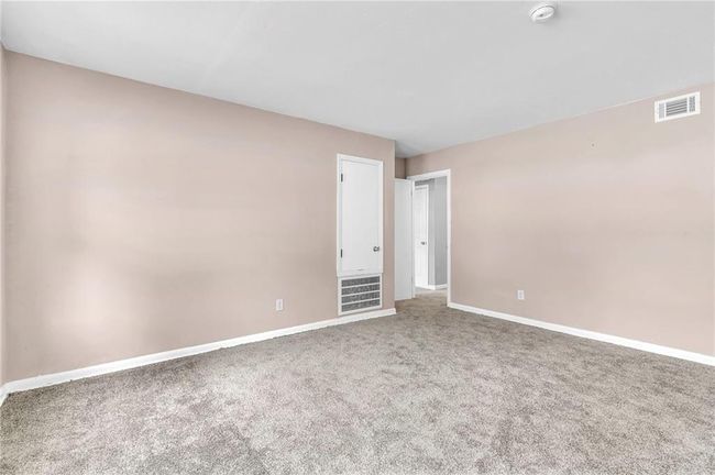 Carpeted spare room featuring visible vents and baseboards | Image 9