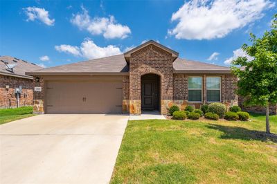 View of front of house featuring a garage and a front lawn | Image 1