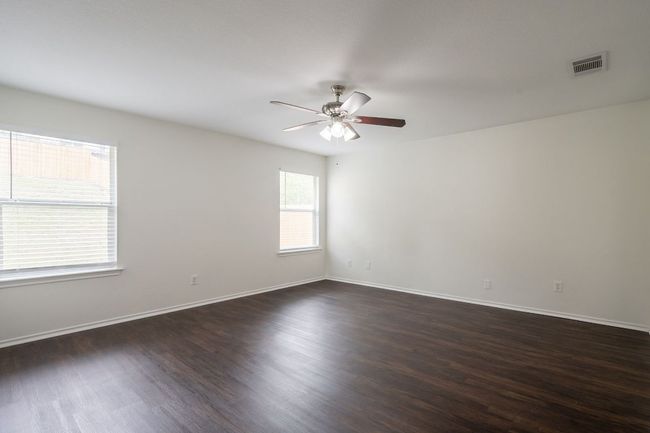 Dining area featuring ceiling fan, dark wood-style floors, and baseboards | Image 14