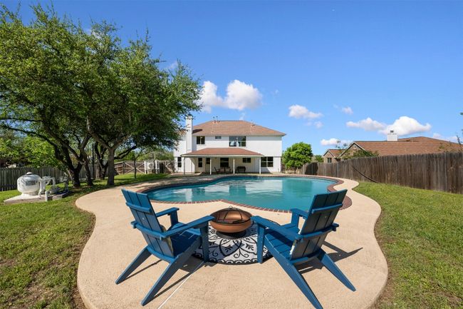 View of pool with a patio area, an outdoor fire pit, and a fenced backyard | Image 32