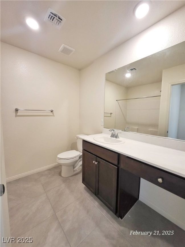 Full bathroom with toilet, recessed lighting, vanity, visible vents, and baseboards | Image 12
