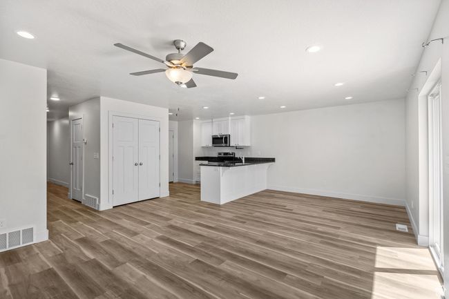 Living room and Semi formal diningroom with ceiling fan, luxury vinyl plank flooring, baseboards, and recessed lighting | Image 16