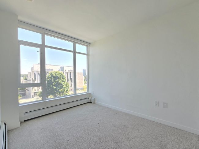 Empty room with a baseboard radiator and carpet floors | Image 9