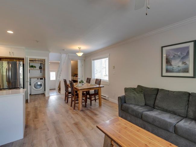 Living area featuring washer / dryer, a healthy amount of sunlight, and crown molding | Image 12