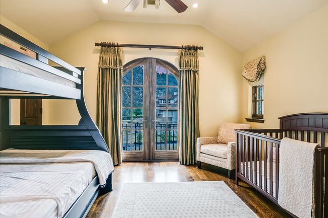 Bedroom featuring french doors, multiple windows, and vaulted ceiling | Image 32