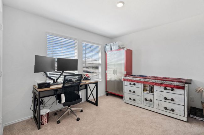 Home office featuring light carpet and baseboards | Image 24