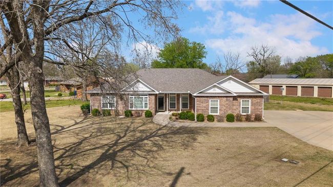 Ranch-style house with brick siding, driveway, and a shingled roof | Image 46