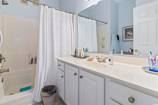 Full bathroom featuring vanity and shower / bathtub combination with curtain | Image 23