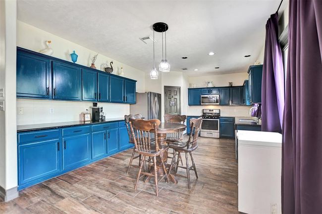 Enjoy the elegance of brand-new flooring throughout the kitchen. | Image 20