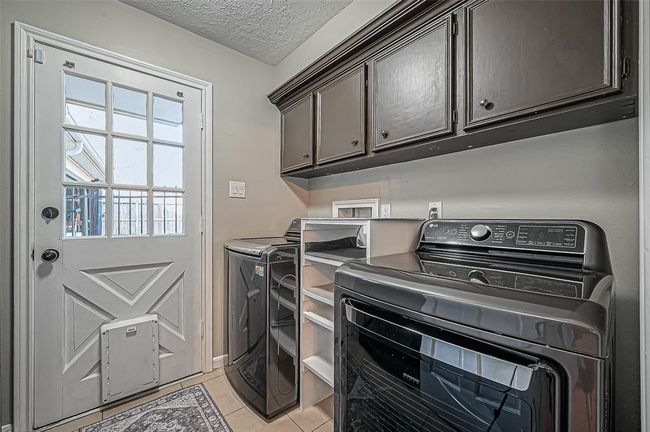 Spacious laundry room with abundant cabinet storage. | Image 22