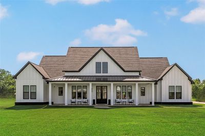 Rear view of house featuring a porch and a yard | Image 1