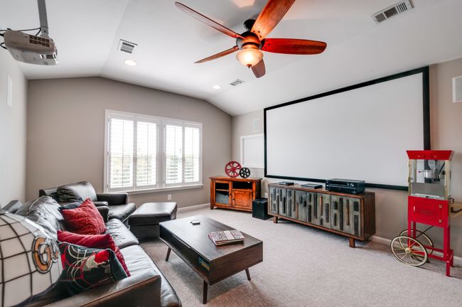 The spacious den has 2 large windows and can be used as a media room or a playroom. There is great storage off that room outfitted with custom shelving. This room can be converted to a 4th bedroom if you finish out the storage into a closet. | Image 33