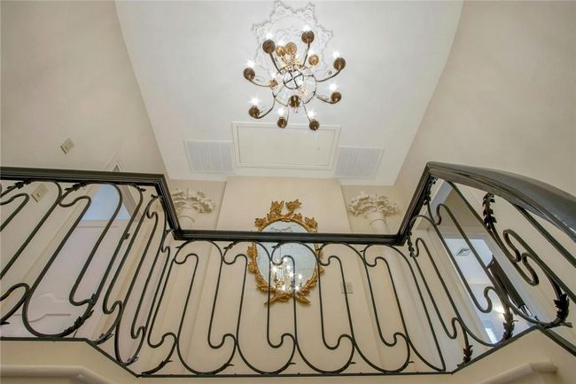 Staircase featuring a chandelier | Image 26