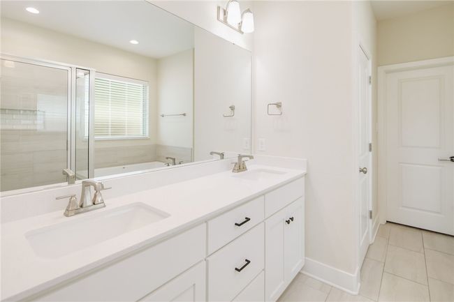 Full bathroom featuring a bath, double vanity, a shower stall, tile patterned flooring, and recessed lighting | Image 13