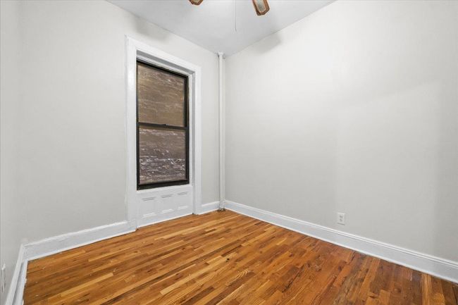 Unfurnished room featuring wood finished floors and ceiling fan | Image 8