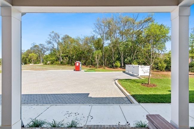 In addition to the front porch, your new home also has a sizable back porch with access to even more parking! Actual photo of home. | Image 34