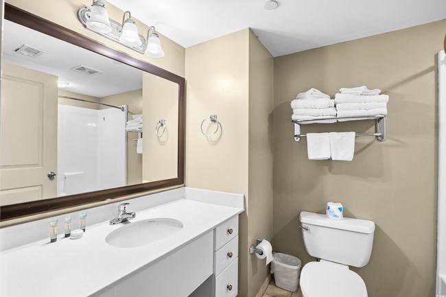 Full bathroom with toilet, vanity, visible vents, and a shower | Image 14