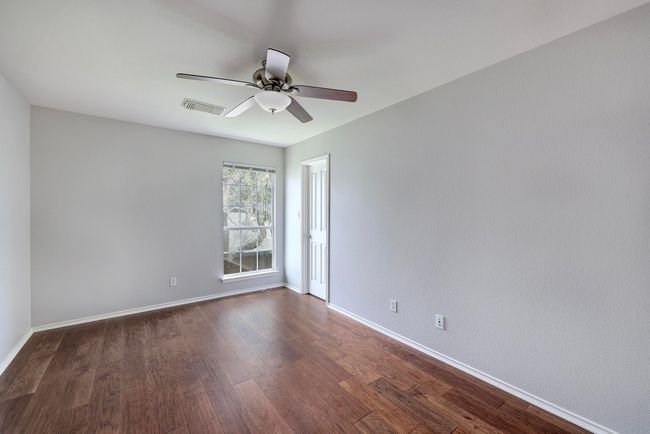 Empty room featuring ceiling fan, dark wood-style floors, and baseboards | Image 28