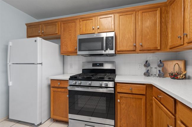Kitchen featuring brown cabinets, stainless steel appliances, and light countertops | Image 8
