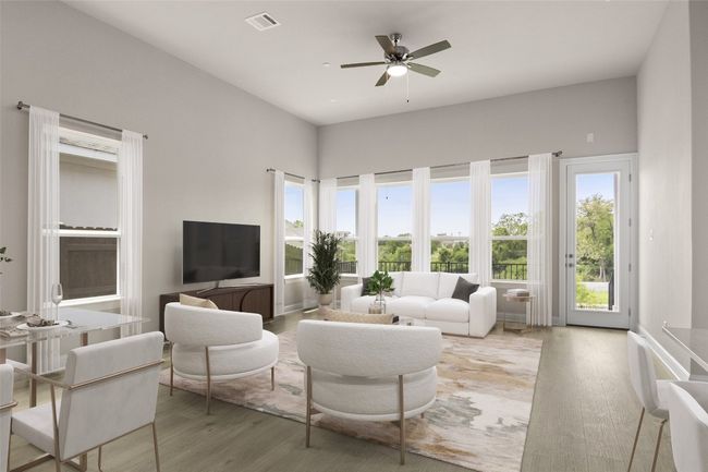 Living room with light wood-style floors and a ceiling fan | Image 7