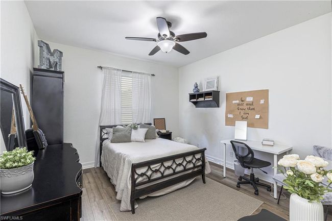 Bedroom with wood finished floors, baseboards, and ceiling fan | Image 14