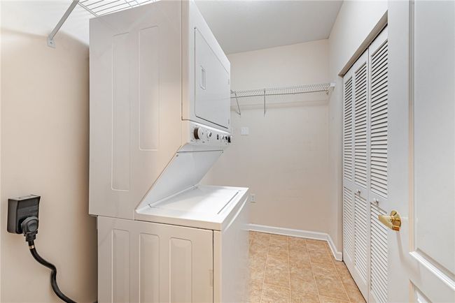 Laundry room with a stackable washer and dryer. | Image 12