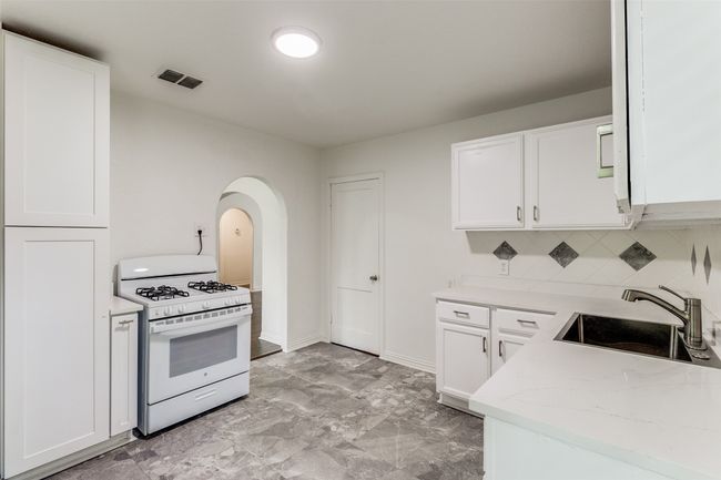 Spare room featuring dark wood-style floors and baseboards | Image 13
