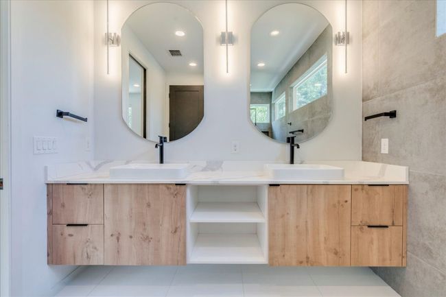 Full bath featuring double vanity, tile walls, tile patterned flooring, and recessed lighting | Image 16