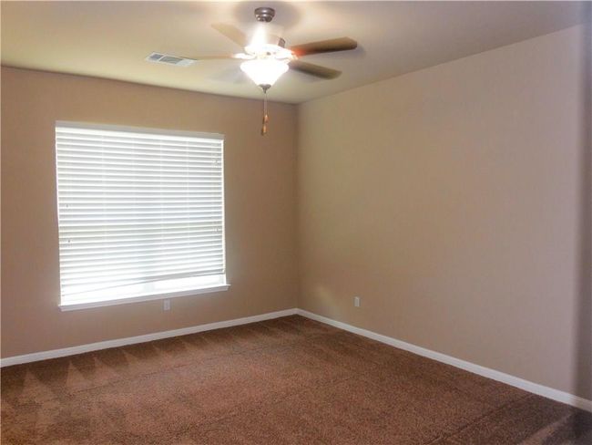 Empty room with a ceiling fan, carpet flooring, and baseboards | Image 8
