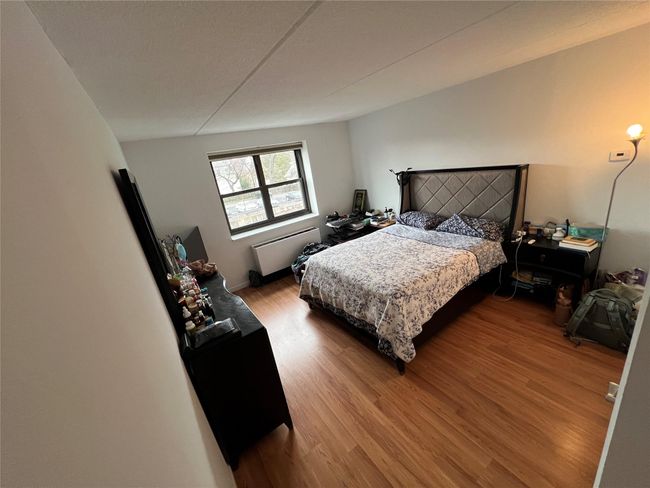 Bedroom with baseboards and wood finished floors | Image 13