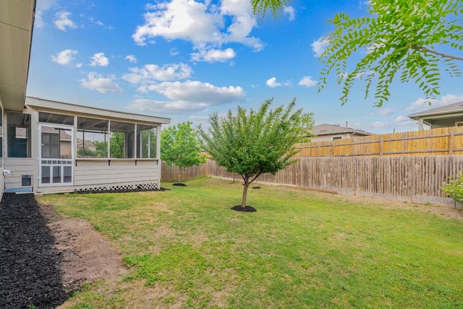 View of yard with a fenced backyard and a sunroom | Image 17