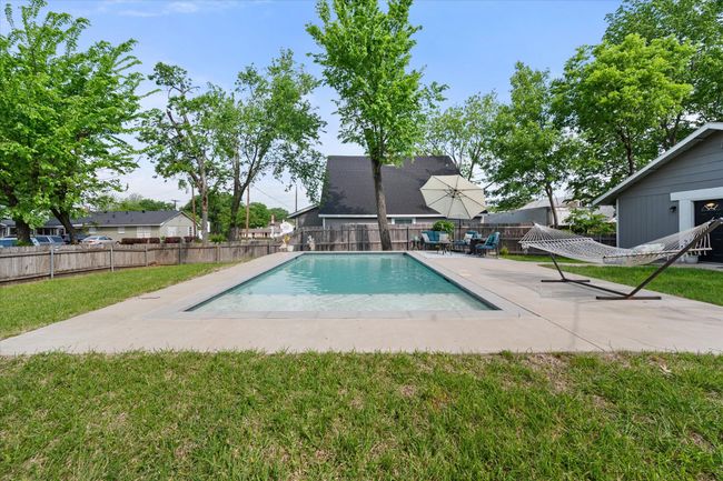 View of swimming pool with a patio | Image 33
