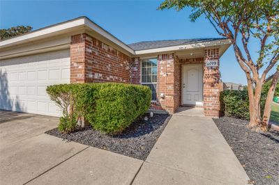 Doorway to property featuring a garage | Image 3