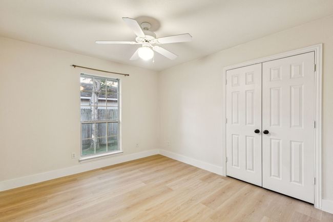 Unfurnished bedroom with light wood-type flooring, a closet, and ceiling fan | Image 15