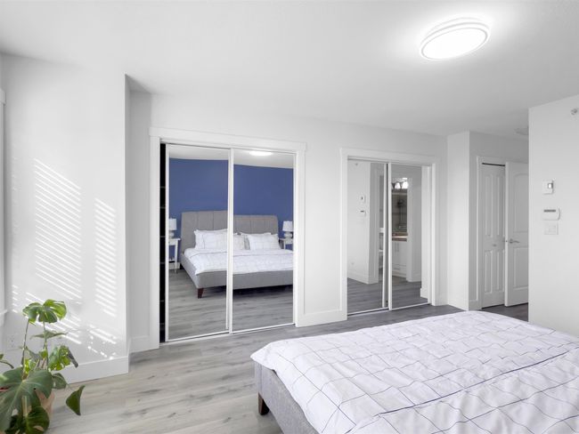 Bedroom featuring baseboards, multiple closets, and wood finished floors | Image 21