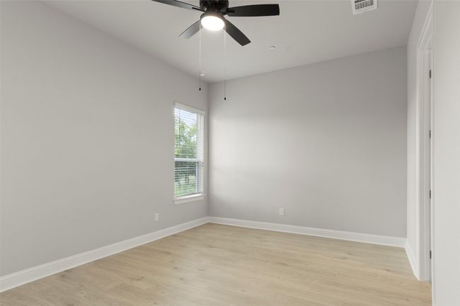 Empty room featuring light wood finished floors and ceiling fan | Image 23