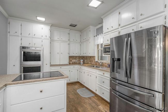 Kitchen features so many cabinets, electric cooktop, microwave | Image 26