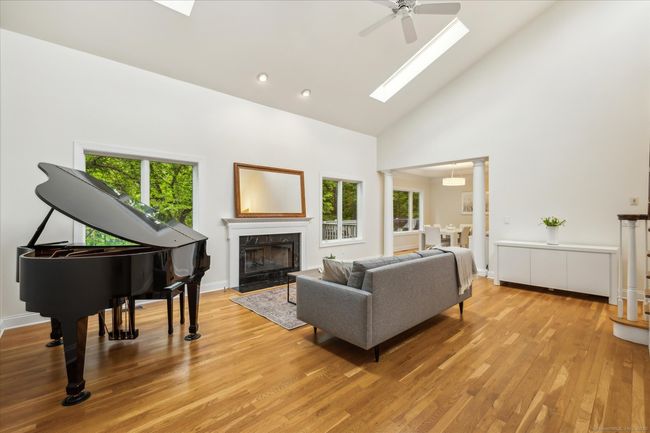 Spacious living room with natural gas fireplace and beautiful outdoor views. | Image 14