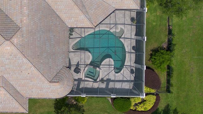From above, the home reveals a stunning custom-designed pool and spa wrapped in an expansive screened enclosure—offering total privacy and a true resort-style retreat. | Image 27