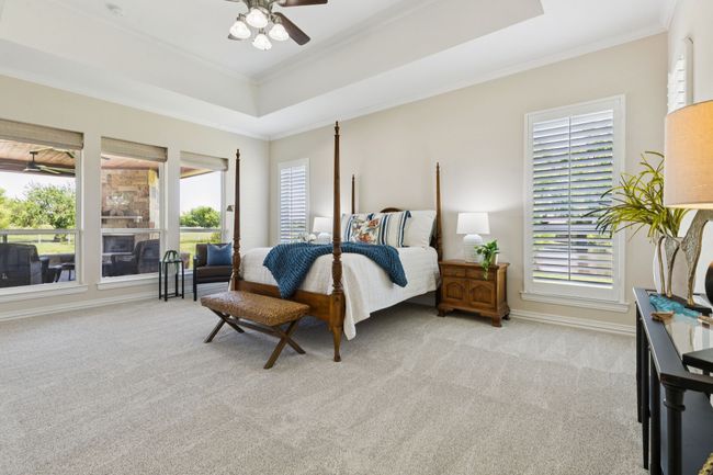 This peaceful retreat has direct access to the outdoor seating area (with a fireplace) and the pool. The room enjoys natural light from the abundance of windows. | Image 16