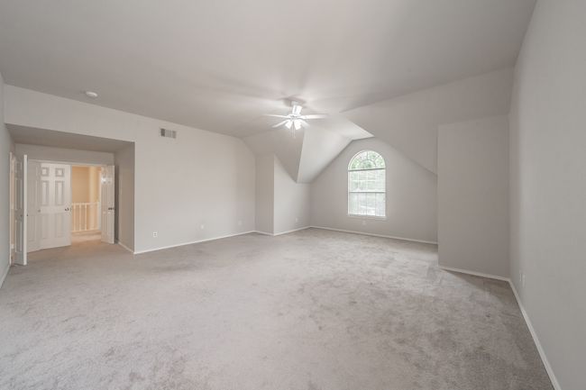 Huge primary bedroom with space for sitting room featuring plush carpeting. | Image 20