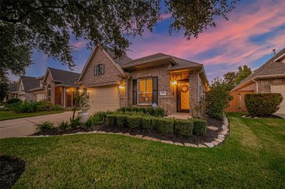 Welcome to this charming home, where a stunning front door invites you into a world of warmth and style. Nestled in the serene Heritage Grand 55+ community, this residence boasts a double garage and meticulously manicured landscaping, ensuring impeccable curb appeal that will make you proud to call it home. Your HOA fees include Front Yard weekly mowing, and include shrub pruning, fertilization, mulching, and insect treatments on a regular schedule. Back yard mowing can be added for a nominal fee. | Image 1